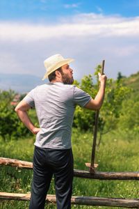 Rear view of man standing against the sky