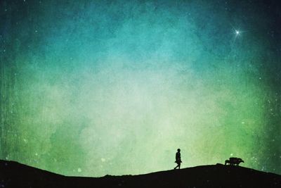 Low angle view of silhouette trees against sky