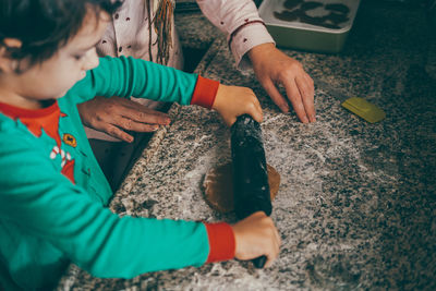 Mother and son strengthens as they share laughter and love while preparing christmas gingerbread