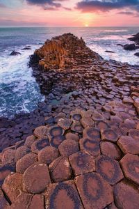 Rocks on shore during sunset