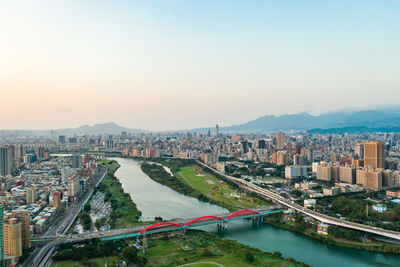 High angle view of river amidst buildings in city against sky