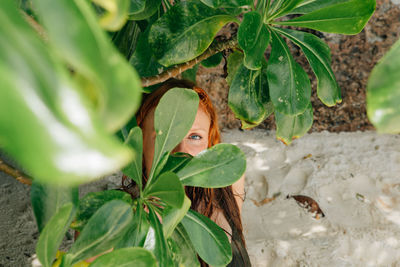 Portrait of woman by leaves