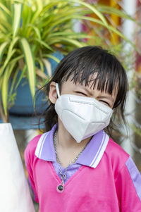 Portrait of smiling girl wearing mask outdoors