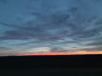 Silhouette of landscape against cloudy sky