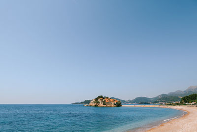 Scenic view of sea against clear blue sky