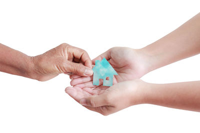 Close-up of hands over white background