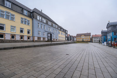 Footpath by building against sky