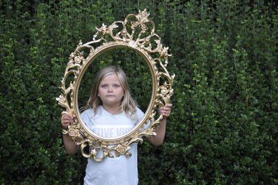 Girl holding a frame