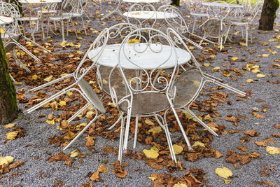 High angle view of empty chairs and table on field