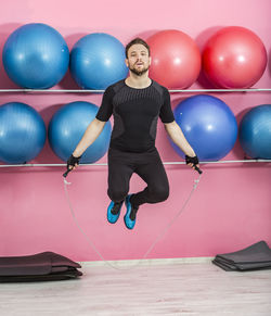 Portrait of man jumping balloons