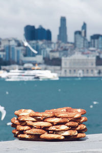 Close-up of sausages on city by sea against sky