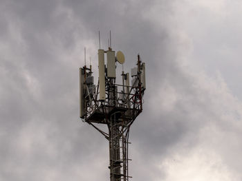 Low angle view of communications tower against sky