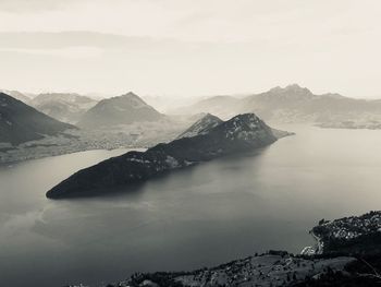 Scenic view of sea and mountains against sky