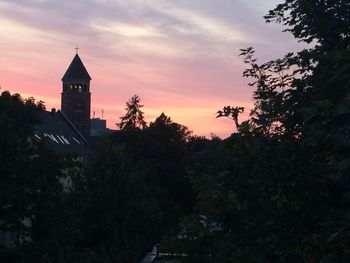 Buildings against sky at sunset