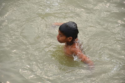 High angle view of boy swimming in water