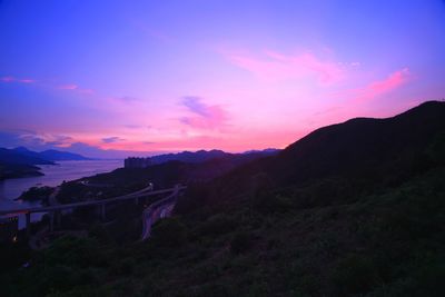 Scenic view of silhouette mountains against sky at sunset