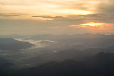 Scenic view of silhouette mountains against sky during sunset