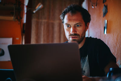 Man using laptop at home