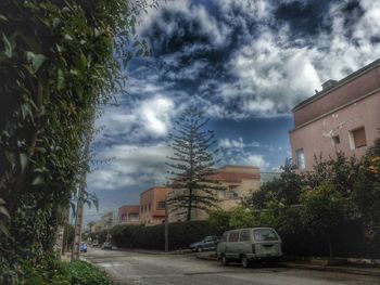 Buildings against cloudy sky