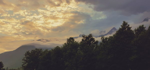 Scenic view of mountains against sky at sunset