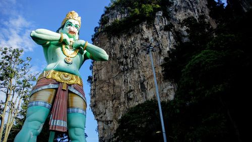 Low angle view of statue against trees