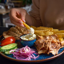 Cropped hand of person preparing food