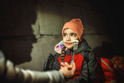 Ukrainian mom feeds little daughter while they sit out attack of russian aggressor in bomb shelter