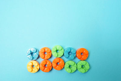 High angle view of multi colored candies against blue background