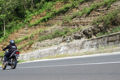 Man riding motorcycle on road