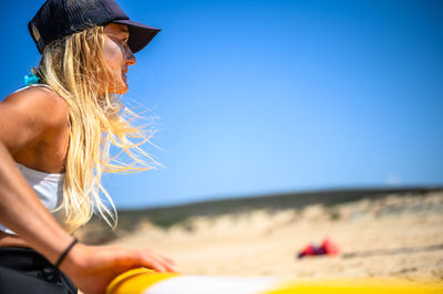 Woman looking away against clear sky