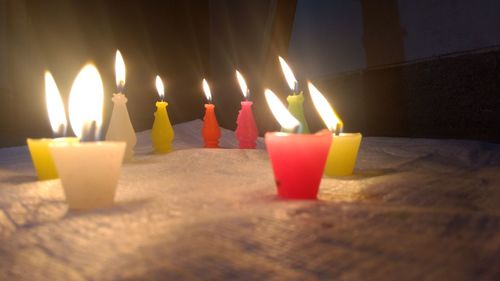 Lit candles on birthday cake