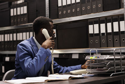 Young woman using mobile phone in office