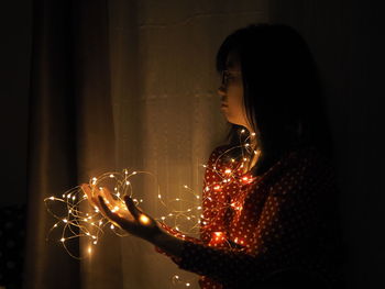 Woman looking at illuminated light painting