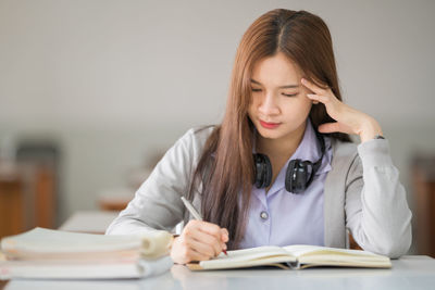 Young woman studying at classroom