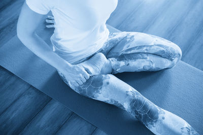 Low section of woman sitting on table