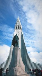 Low angle view of building against cloudy sky