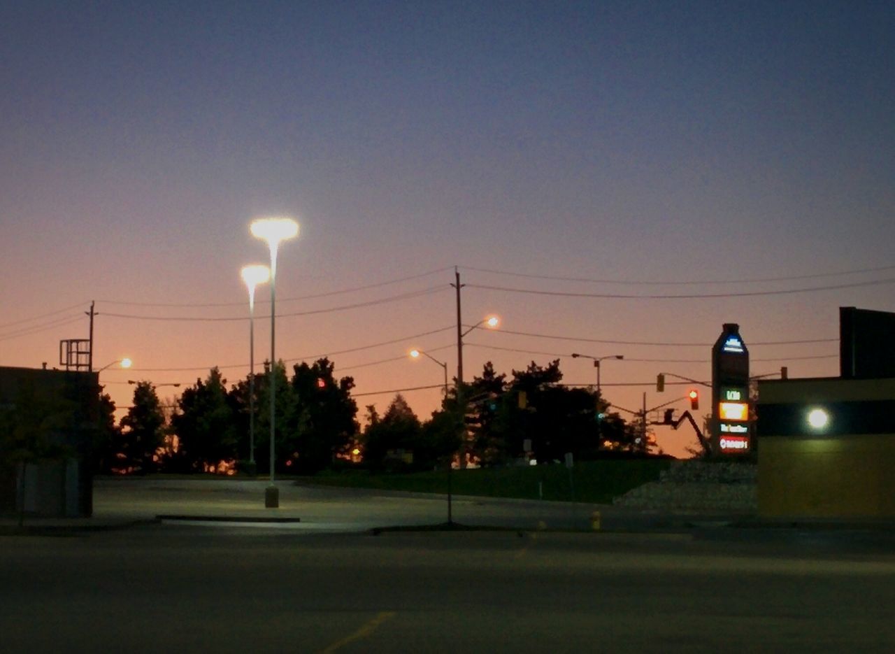 illuminated, lighting equipment, transportation, street light, power line, cable, outdoors, electric light, city life, solitude, vibrant color, tranquil scene, no people