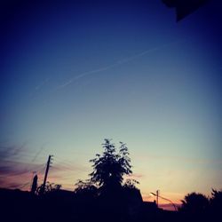 Low angle view of silhouette trees against sky at dusk