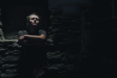 Portrait of depressed woman in basement