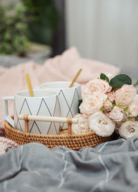 Coffee cups with roses bouquet, romantic breakfast with flowers