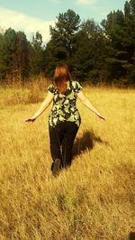 Woman standing on grassy field