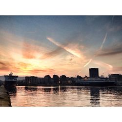 City at waterfront during sunset
