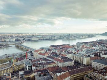 High angle view of river amidst buildings in city against sky