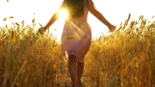 Woman standing on field against sky