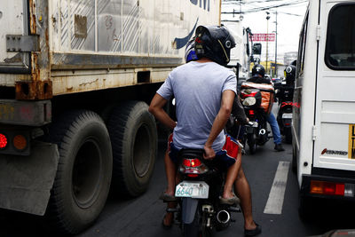 Rear view of man working on street