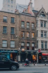 Cars on street by buildings in city