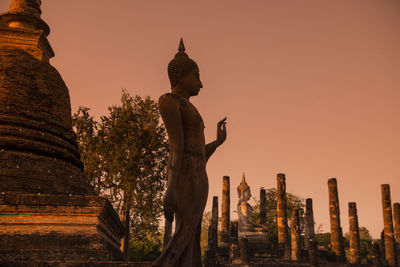 Statue of a temple against building