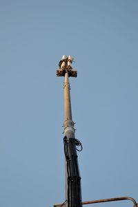 Low angle view of statue against clear blue sky