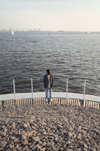 Young businessman standing on promenade