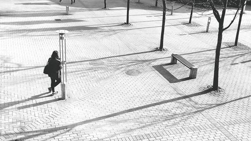 Shadow of woman on footpath